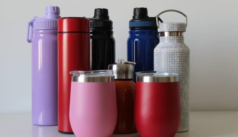 Colorful variety of insulated bottles and tumblers for beverages.