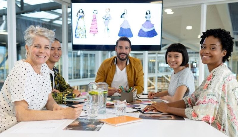 Team of diverse professionals collaborating in a modern office meeting.