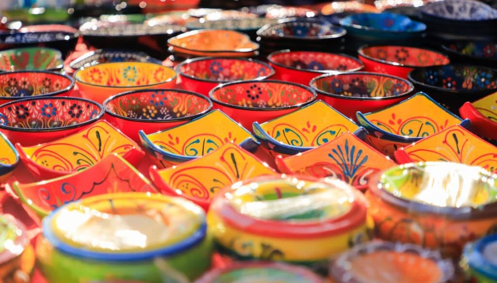 closeup of different types of pots and oil pots handmade and sold at a street market