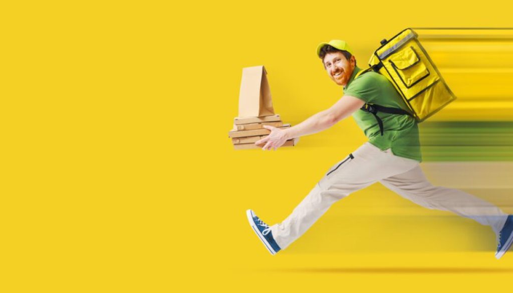 Happy delivery person with packages and backpack on yellow background.
