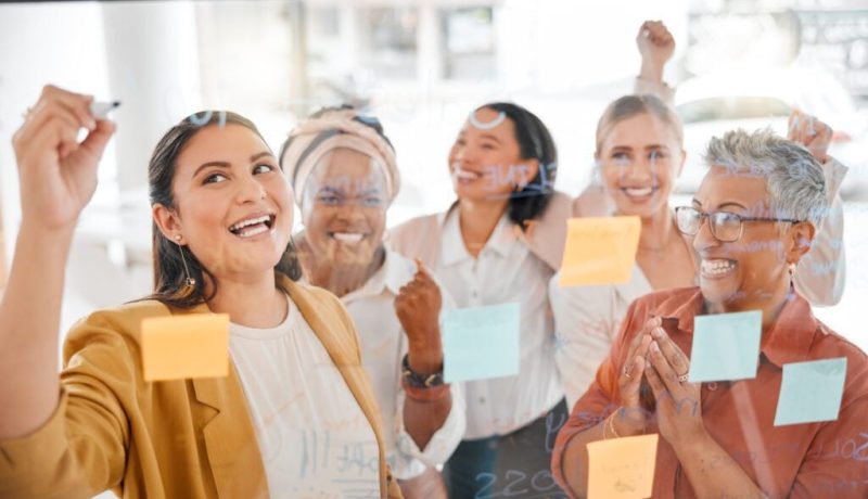 Team planning success or woman writing a winning marketing strategy or advertising plan for business ideas Sticky notes meeting or excited people working on global startup project target or goals