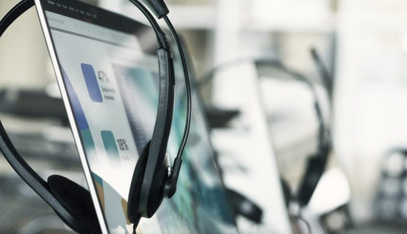 Close up headset of call center on office table operation job concept