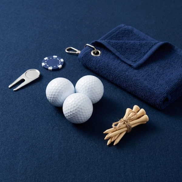 Golf accessories including balls, towel, tees, and marker on blue background.