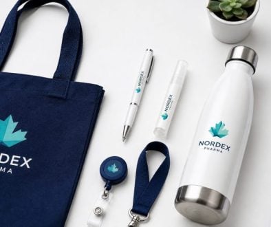 Promotional tote bag and water bottle with Nordx Pharma logo for branding.
