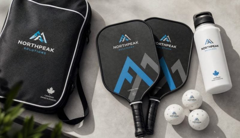 Branded corporate pickleball paddles, custom balls, carry case, and water bottle for a Canadian business tournament