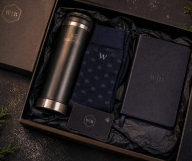 Elegant gift set including a stainless steel thermos, socks, and notebook.