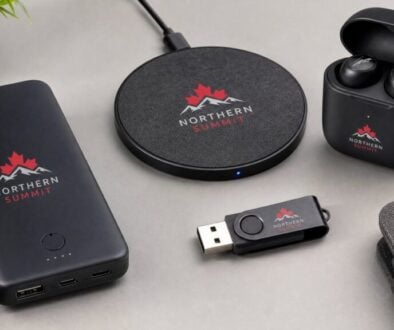 Custom branded tech accessories for Canadian trade shows — power bank, wireless charger, earbuds, and USB drive