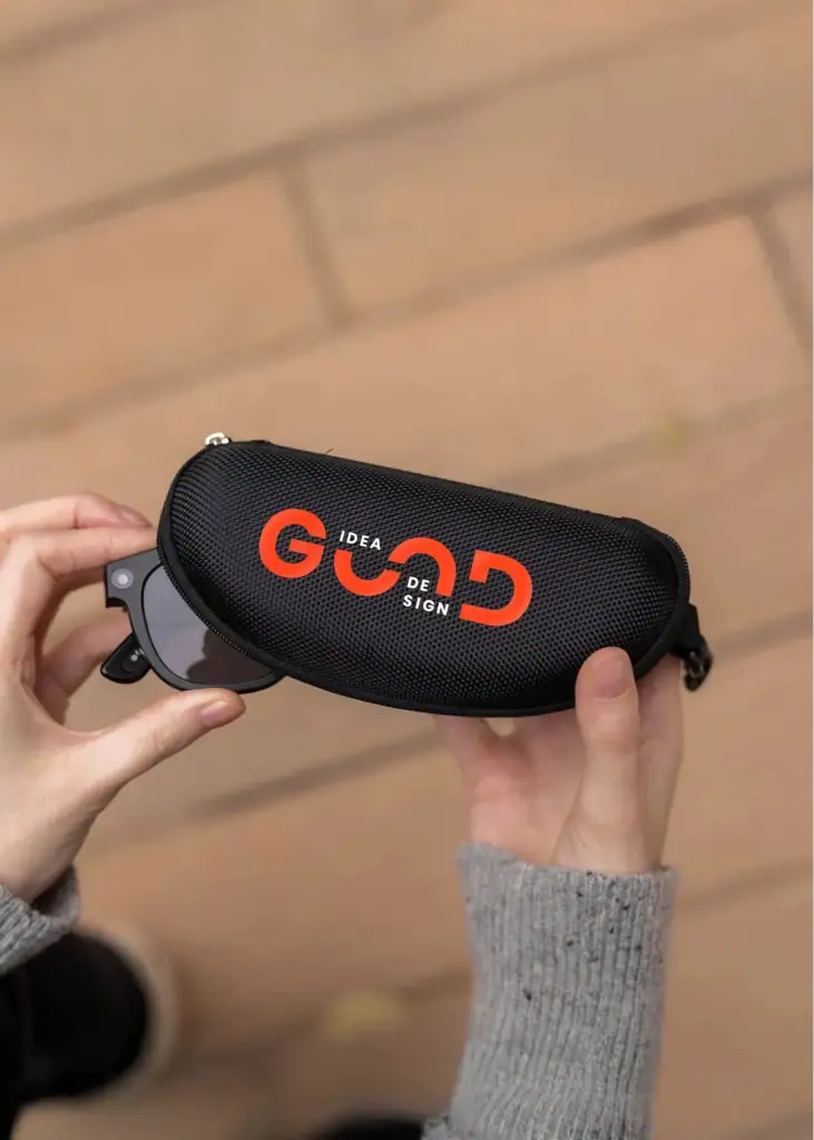 Black sunglasses case with orange and white logo from CanPromos.